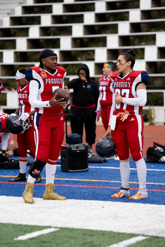 Protagonist apparel clothing owner talking to QB on sidelines